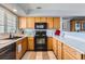 Updated kitchen boasts black appliances, light wood cabinets, and neutral countertop and backsplash at 8199 Welby Rd # 3102, Denver, CO 80229