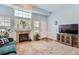 Cozy living room showcasing a fireplace, TV, and a comfortable green sofa at 8199 Welby Rd # 3102, Denver, CO 80229