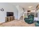 Inviting living room with plush carpeting, comfortable seating, and a large TV at 8199 Welby Rd # 3102, Denver, CO 80229