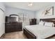 Bedroom with cozy carpet, a large window, and dark wood furniture at 8199 Welby Rd # 3102, Denver, CO 80229