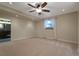 Spacious bedroom with neutral carpet, ceiling fan, and bright window for a welcoming and comfortable ambiance at 24733 E Park Crescent Dr, Aurora, CO 80016