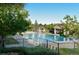 Beautiful community pool area with cabanas, mature trees, and lush landscaping for a resort-style living experience at 24733 E Park Crescent Dr, Aurora, CO 80016