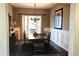 Traditional dining room featuring a wood table, chandelier lighting, wainscoting and a large window at 24733 E Park Crescent Dr, Aurora, CO 80016