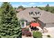 Two-story home featuring a stone facade, a large window, and an outdoor seating area with a fire pit at 24733 E Park Crescent Dr, Aurora, CO 80016
