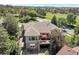 A beautiful backyard featuring a porch, stone patio and an outdoor lounge area, set amongst mature trees at 24733 E Park Crescent Dr, Aurora, CO 80016