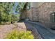Exterior view of a home with stone accents, landscaped with natural stone, shrubbery and a side walk at 24733 E Park Crescent Dr, Aurora, CO 80016
