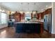 Spacious kitchen with stainless steel appliances, a wine fridge, and a large island at 24733 E Park Crescent Dr, Aurora, CO 80016
