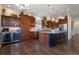 Well-equipped kitchen boasting a wine fridge, island, and stainless-steel appliances at 24733 E Park Crescent Dr, Aurora, CO 80016