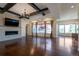 Open living room with hardwood floors, coffered ceiling with wood beams, fireplace and lots of natural light at 24733 E Park Crescent Dr, Aurora, CO 80016