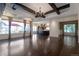 Spacious living room with hardwood floors, wood-beamed ceilings, and large windows overlooking the yard at 24733 E Park Crescent Dr, Aurora, CO 80016