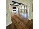 Open living room featuring wood floors, coffered ceilings with wood beams, and a modern fireplace at 24733 E Park Crescent Dr, Aurora, CO 80016