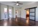 Spacious main bedroom featuring wood floors, and an en-suite bathroom with barn door access at 24733 E Park Crescent Dr, Aurora, CO 80016