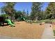 Community playground with slides, climbing structures, and a soft wood chip surface for safe play at 24733 E Park Crescent Dr, Aurora, CO 80016