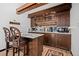 Kitchen with wood cabinets and breakfast bar at 12105 Vaseen Ct, Conifer, CO 80433