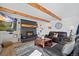 Cozy living room with fireplace and wood beams at 12105 Vaseen Ct, Conifer, CO 80433