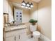 Guest bathroom with granite countertop and white cabinetry at 10976 W 55Th Ln, Arvada, CO 80002