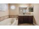 Elegant bathroom with double vanity, soaking tub, and updated fixtures at 10976 W 55Th Ln, Arvada, CO 80002