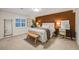 Basement bedroom with brown accent wall and wooden bench at 10976 W 55Th Ln, Arvada, CO 80002