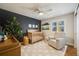 Bright Bedroom featuring a crib, armchair, and ample natural light at 10976 W 55Th Ln, Arvada, CO 80002