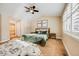 Main bedroom with a green velvet bed and ensuite bath at 10976 W 55Th Ln, Arvada, CO 80002