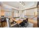 Spacious dining area with a wooden table and seating for six, adjacent to living room at 10976 W 55Th Ln, Arvada, CO 80002