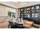 Open concept dining room with a wooden table, black shelving, and views to living room at 10976 W 55Th Ln, Arvada, CO 80002