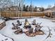 Backyard fire pit surrounded by chairs in the snow at 10976 W 55Th Ln, Arvada, CO 80002