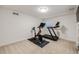 Basement home gym with stationary bike and treadmill at 10976 W 55Th Ln, Arvada, CO 80002