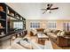 Sun-drenched living room with comfortable seating and built-in shelving at 10976 W 55Th Ln, Arvada, CO 80002