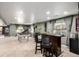 Spacious basement features a pool table, bar with stools, and sports decor, perfect for entertaining at 10221 Nucla St, Commerce City, CO 80022