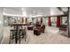 Finished basement featuring comfortable seating, projector screen, and ambient lighting at 10221 Nucla St, Commerce City, CO 80022