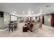 Spacious finished basement featuring comfortable seating, projector screen, and ambient lighting at 10221 Nucla St, Commerce City, CO 80022