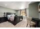 Cozy bedroom featuring a dark sleigh bed with decorative lamps, and a desk with an upholstered chair at 10221 Nucla St, Commerce City, CO 80022
