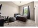 Bright bedroom featuring a large window, soft carpet, and a cozy gray beanbag chair at 10221 Nucla St, Commerce City, CO 80022