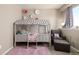 bedroom featuring a whimsical canopy bed, pink rug, and decorative wall flowers at 10221 Nucla St, Commerce City, CO 80022