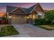 Charming exterior view of a two-story home featuring a stone and siding facade, well-maintained landscaping and driveway at 10221 Nucla St, Commerce City, CO 80022