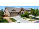 Exterior front view of a home featuring a well-kept lawn, landscape, a two-car garage and a long driveway at 10221 Nucla St, Commerce City, CO 80022