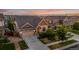 Attractive exterior home view featuring a well-kept lawn, landscape, a two-car garage and a driveway at 10221 Nucla St, Commerce City, CO 80022