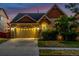 Charming exterior view of a two-story home featuring a stone and siding facade, well-maintained landscaping and driveway at 10221 Nucla St, Commerce City, CO 80022
