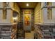 Inviting front porch featuring stone pillars, a rocking chair, 'hello' door mat and a brick entrance at 10221 Nucla St, Commerce City, CO 80022