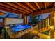 Outdoor hot tub with wooden beams and stairs leading up to the deck, creating a perfect relaxation and entertainment space at 10221 Nucla St, Commerce City, CO 80022
