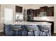 Kitchen featuring stainless appliances, a breakfast bar with seating, and granite countertops at 10221 Nucla St, Commerce City, CO 80022