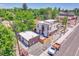 Aerial view of the home with a detached garage, landscaping, and modern architectural style at 1491 S York St, Denver, CO 80210