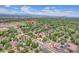 Aerial view of the property and surrounding neighborhood featuring mature trees and city views at 1491 S York St, Denver, CO 80210