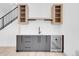 Contemporary bar area featuring gray cabinets, a wine refrigerator, and open shelving at 1491 S York St, Denver, CO 80210