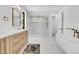 Luxurious bathroom features a walk-in glass shower, modern soaking tub, double sink vanity, and gold hardware at 1491 S York St, Denver, CO 80210