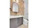 Stylish powder room with textured wall, modern vanity, and elegant fixtures in a sleek design at 1491 S York St, Denver, CO 80210