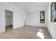 Clean bedroom featuring wood floors, a walk-in closet, and a window, offering a simple and functional space at 1491 S York St, Denver, CO 80210