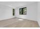 Bright, minimalist bedroom with large windows, light hardwood floors and white walls provides a serene, airy atmosphere at 1491 S York St, Denver, CO 80210