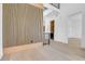 Elegant entryway with light wood floors, modern wood accent wall, and access to staircase and other rooms at 1491 S York St, Denver, CO 80210